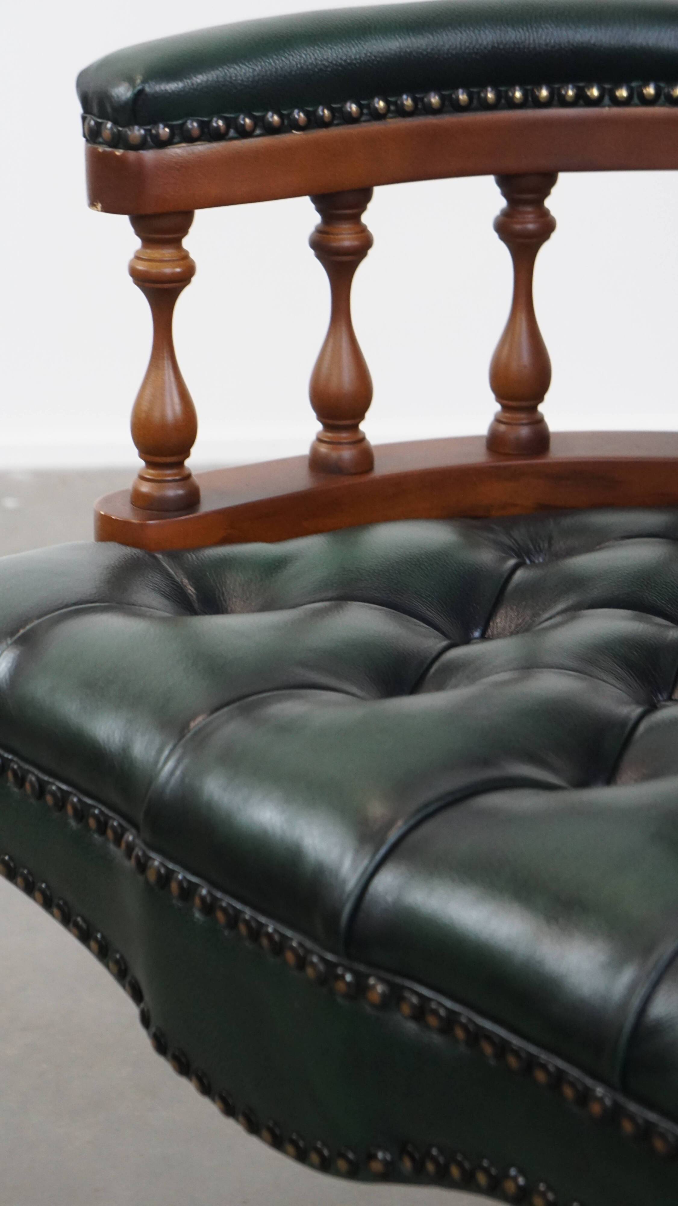Dark green chesterfield office chair in cowhide leather on wheels