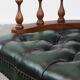 Dark green leather Chesterfield office chair on wheels.