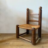 Low brutalist straw chair called fireplace chair