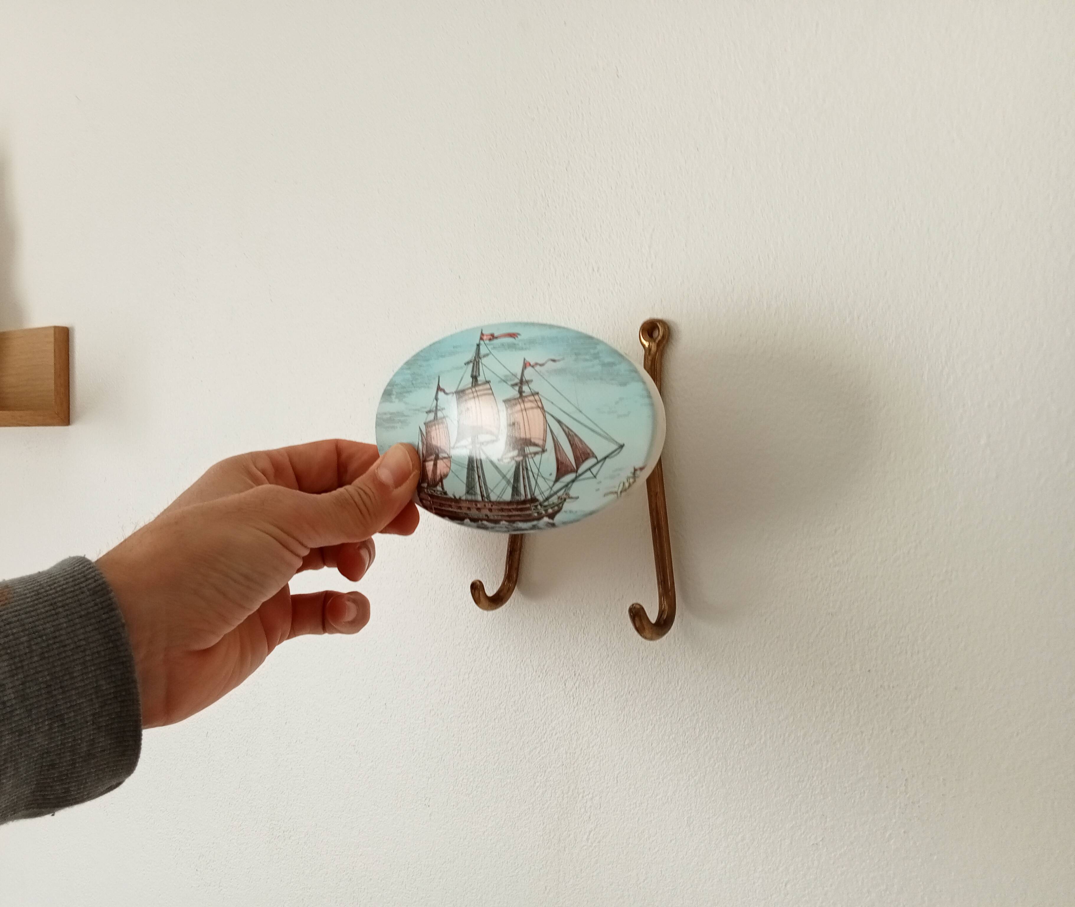 Vintage wall coat hook in brass and Bakelite.