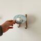 Vintage wall coat hook in brass and Bakelite.