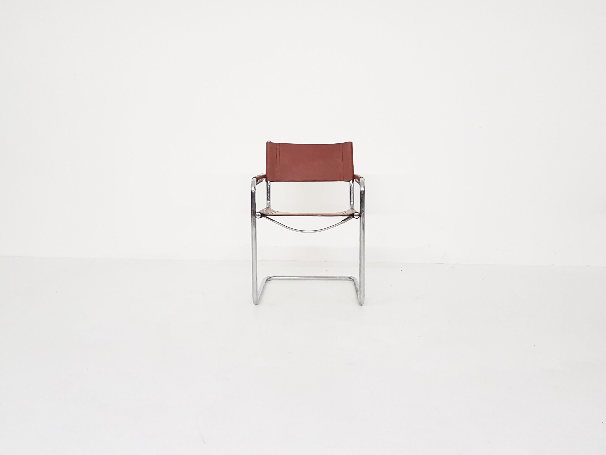 Tubular dining chair with arm rests, 1970's