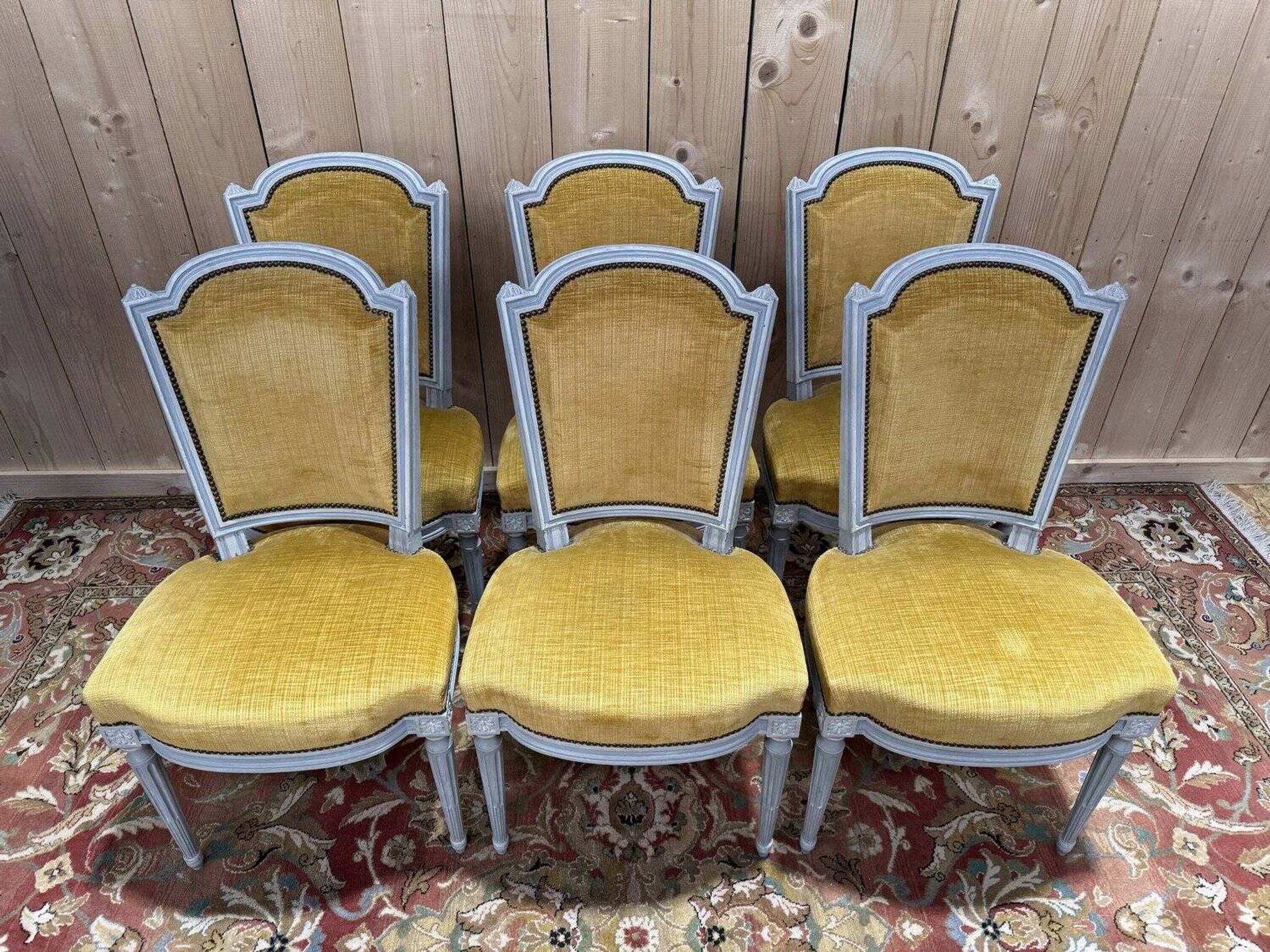 Set of 6 Louis XVI style chairs with polished wood and velvet.