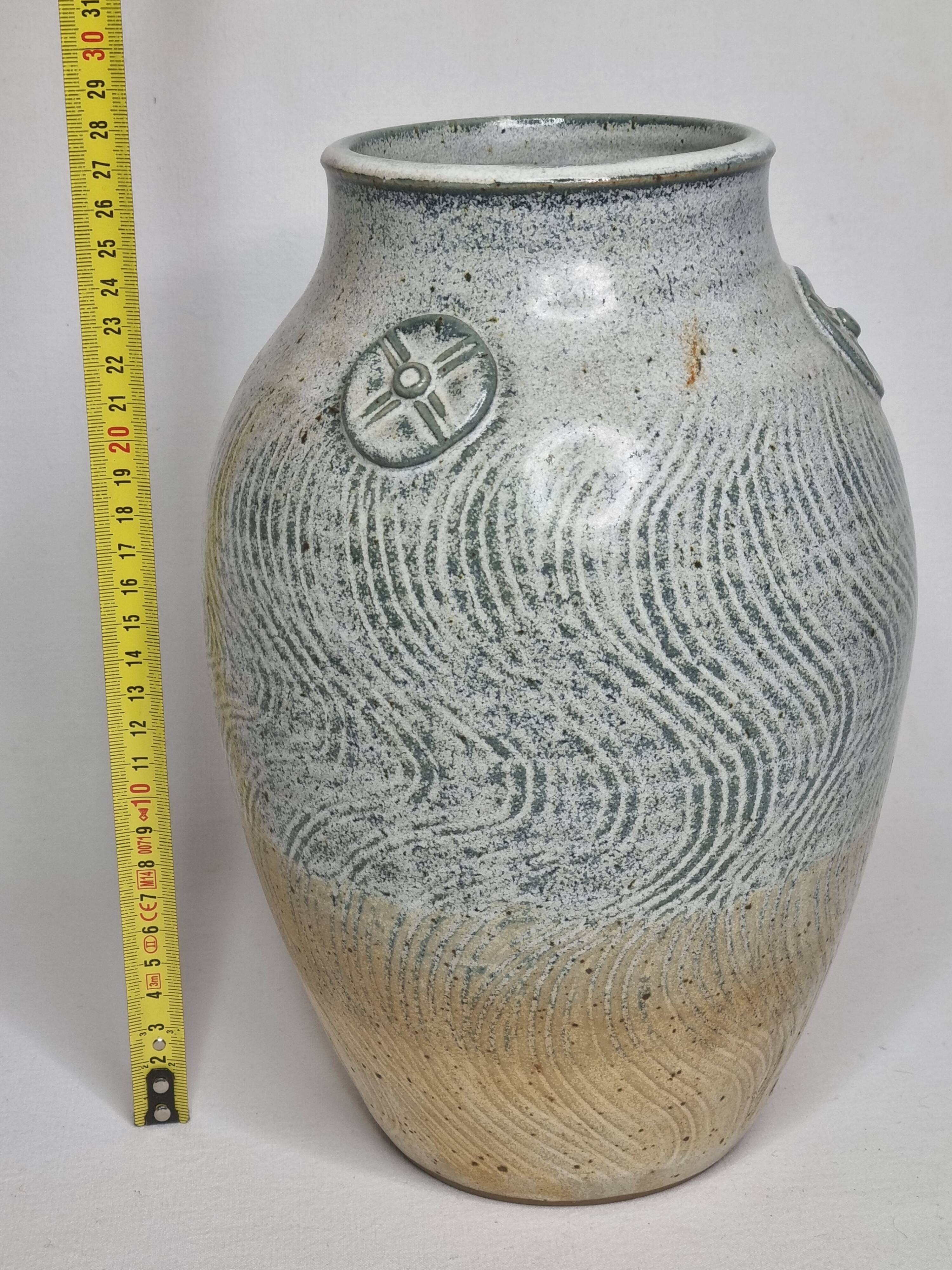 Stoneware vase signed by Sylvie Dufour, incised decoration and relief medallions, 28 cm.