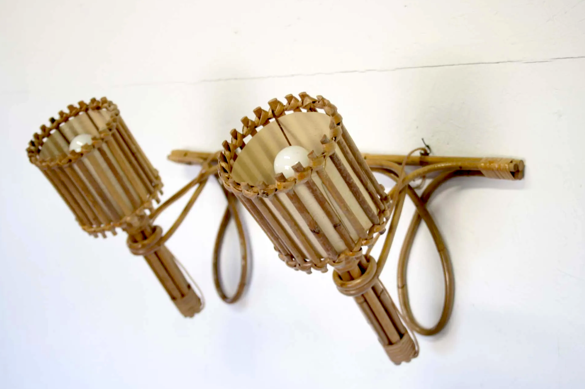 Pair of Louis Sognot rattan sconces