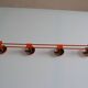 Vintage 70s orange lacquered metal 4-hook wall coat rack