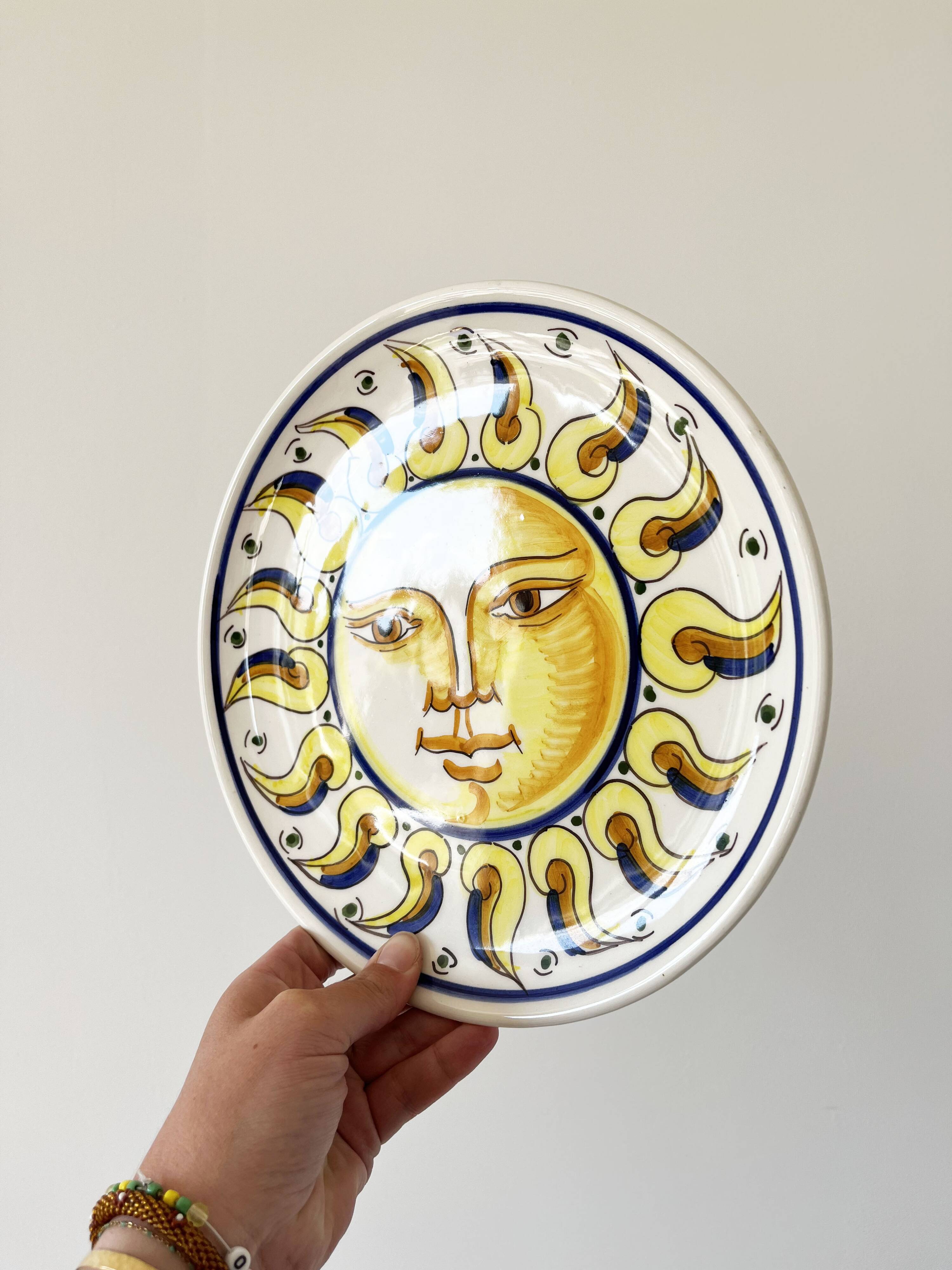 Decorative ceramic plate with sun face