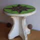 Small wooden stool painted with a star design.