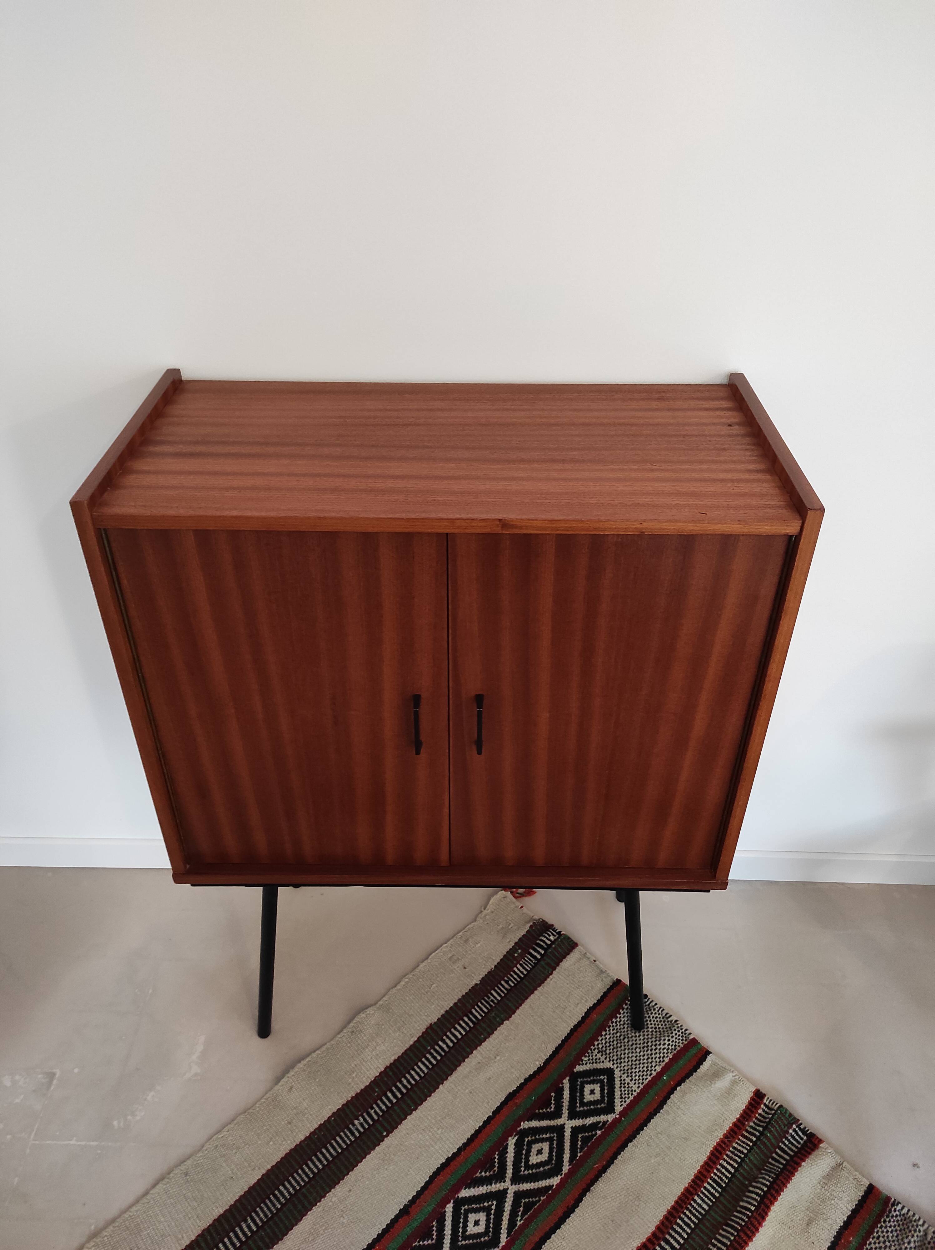 Piece of furniture on high feet metal compass