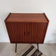 Piece of furniture on high feet metal compass