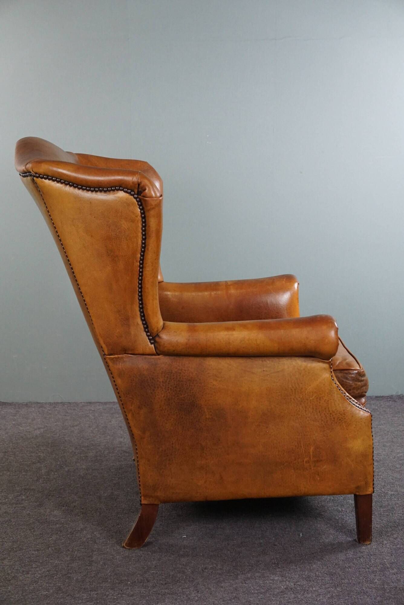 Wingback chair made of sheepskin leather in a light honey color
