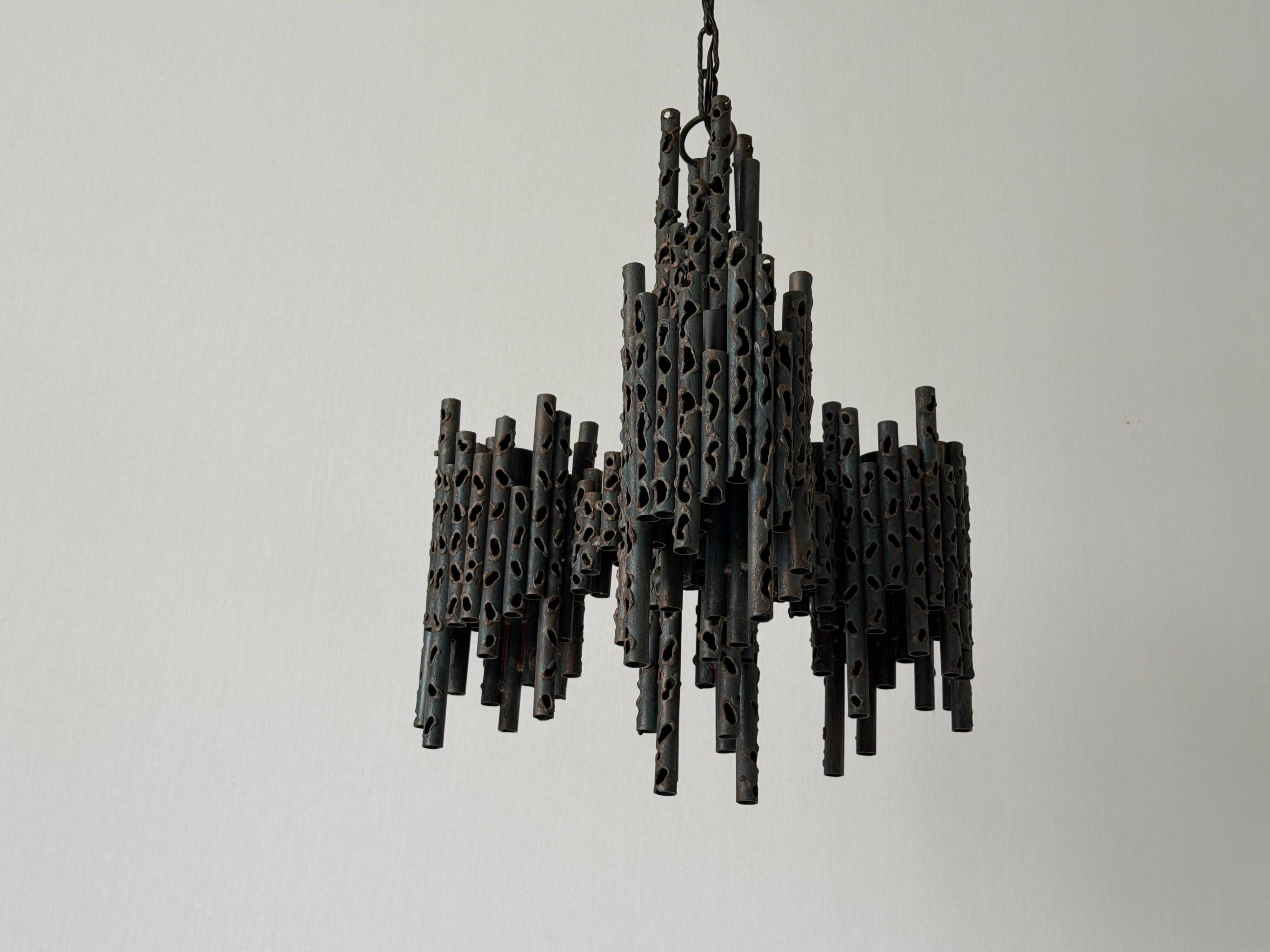 Three-armed suspended lamp in wrought iron, brutalist design, 1960s, Italy.