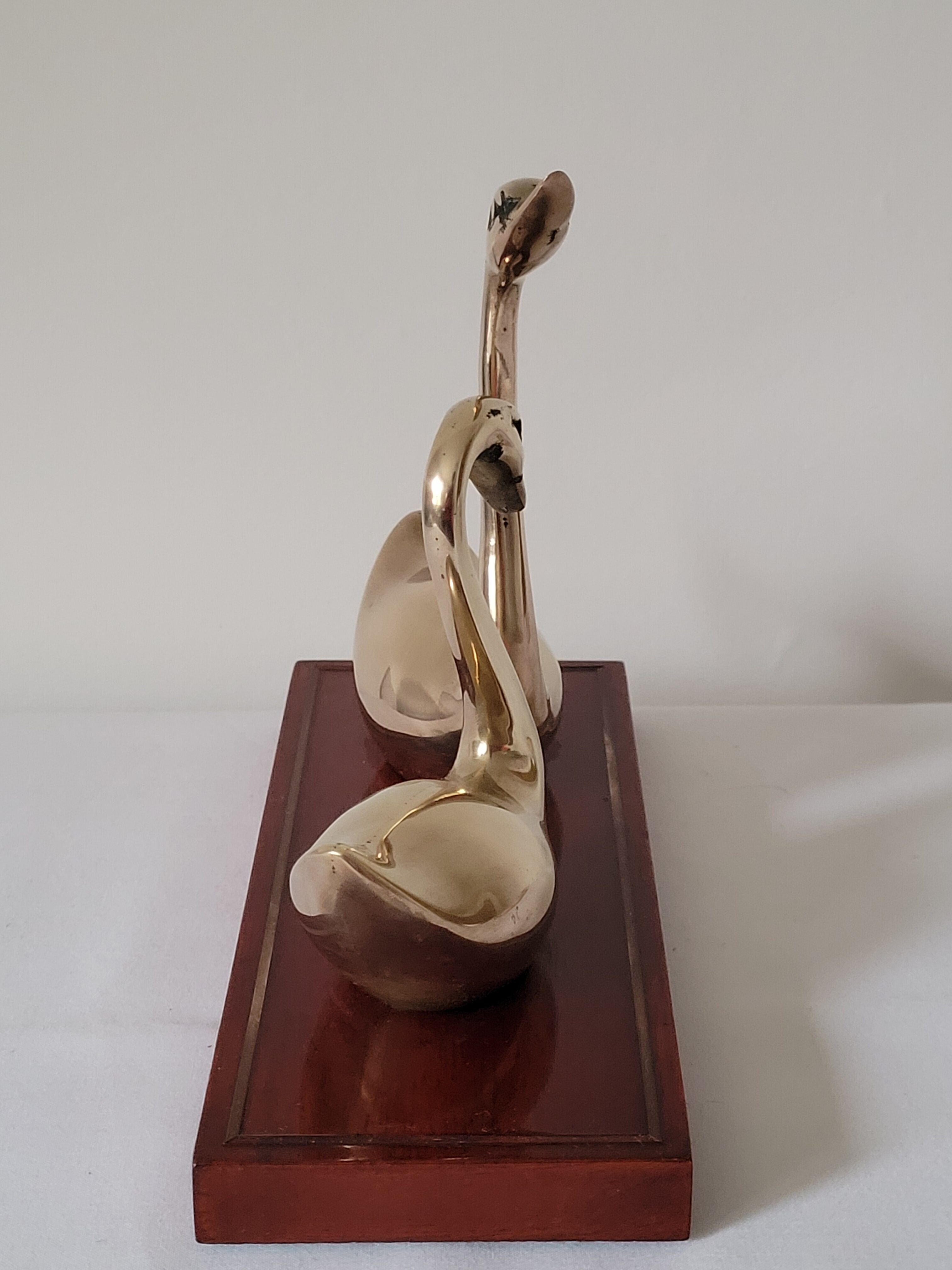 Duo of brass swans on base