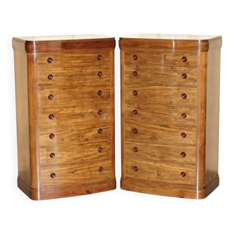 Pair of tall walnut chests of drawers with curved fronts in country style.
