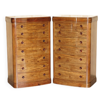 Pair of tall walnut chests of drawers with curved fronts in country style.