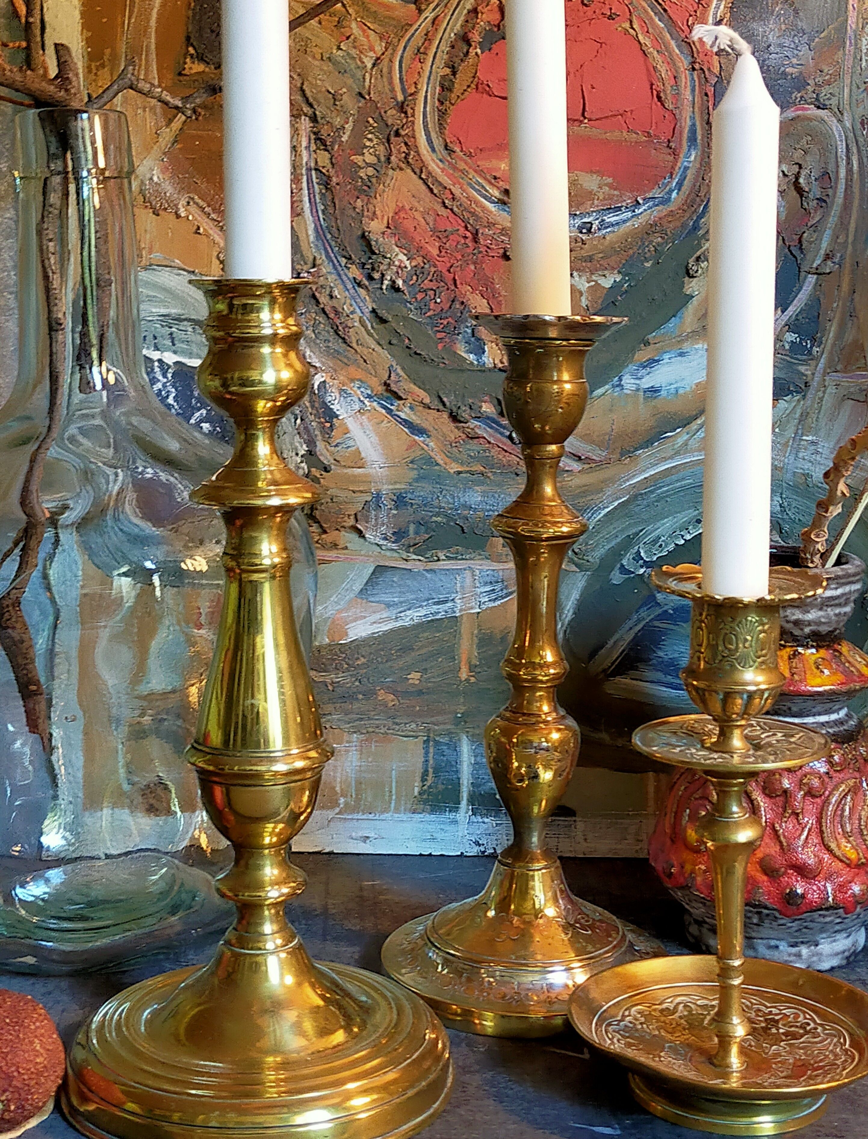Duo of solid brass and gold metal candle holders worked old