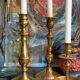 Duo of solid brass and gold metal candle holders worked old