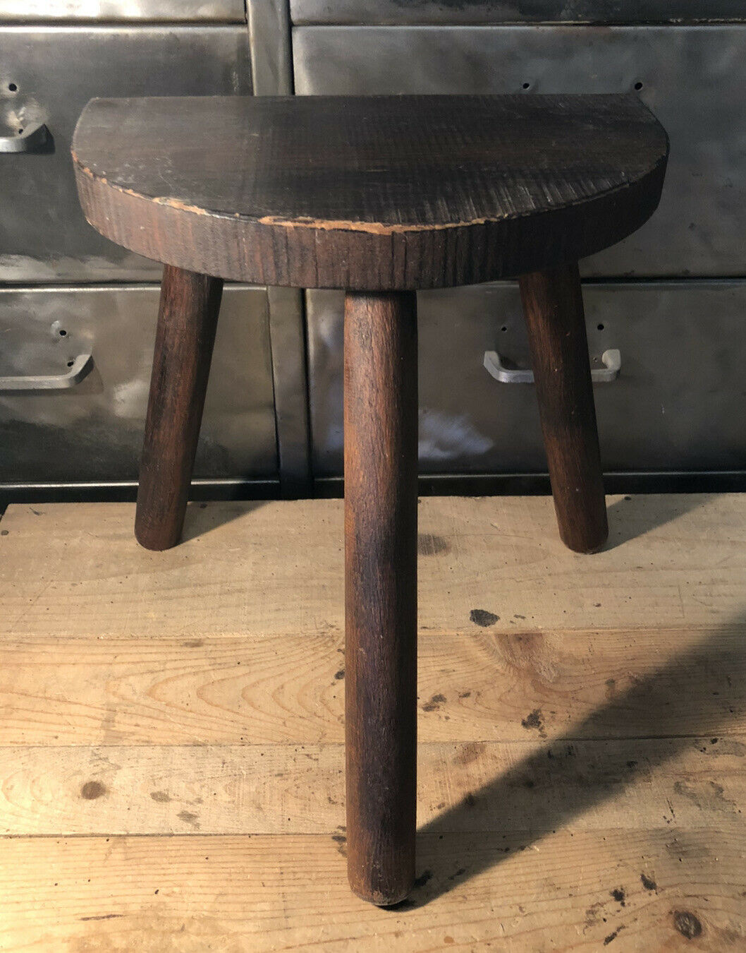 Wooden milking stool on tripod base