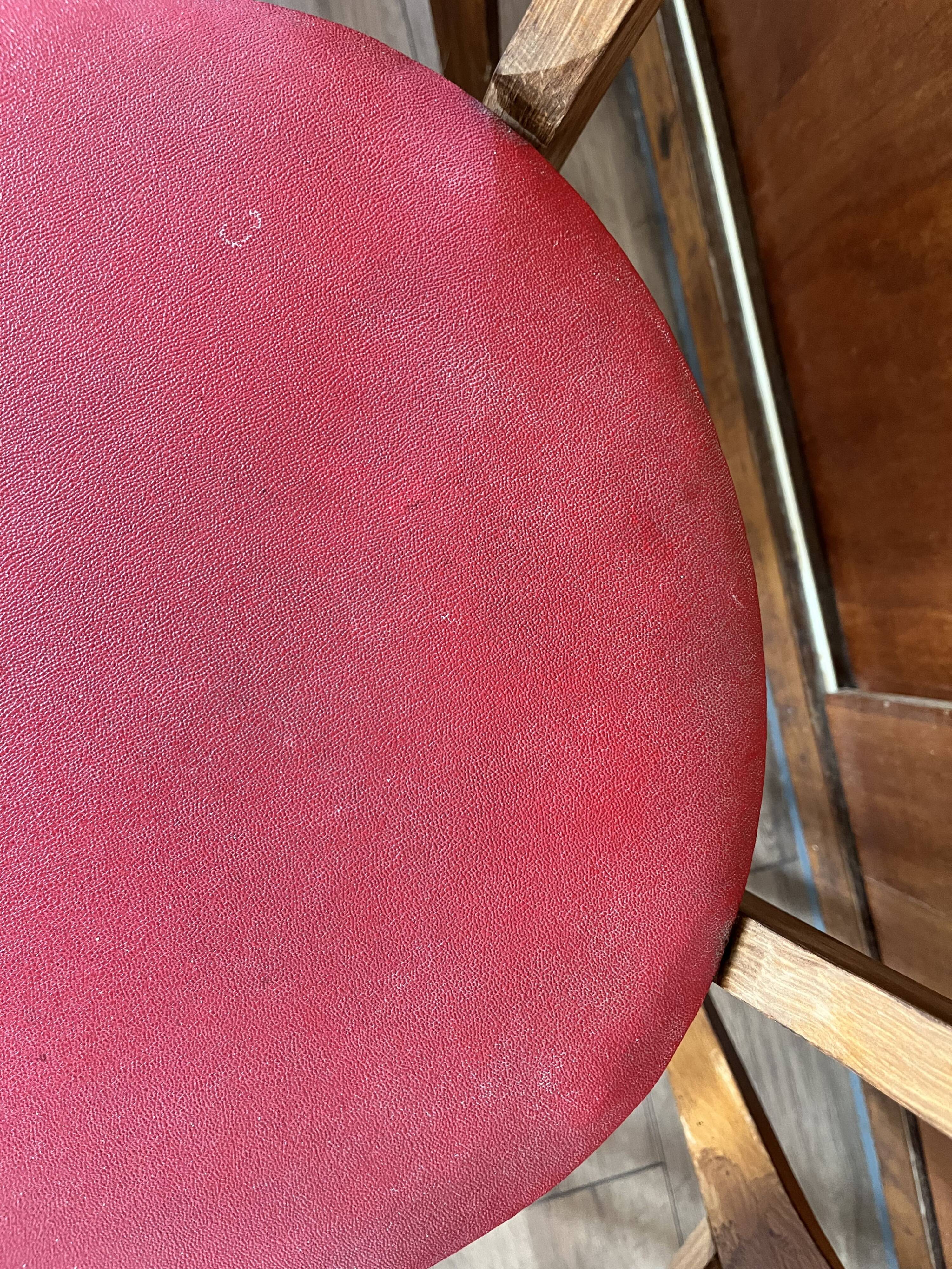 Set of 4 wooden chairs with red vinyl.