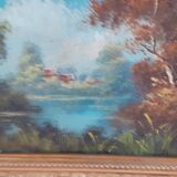Old oil with golden frame. The lake.