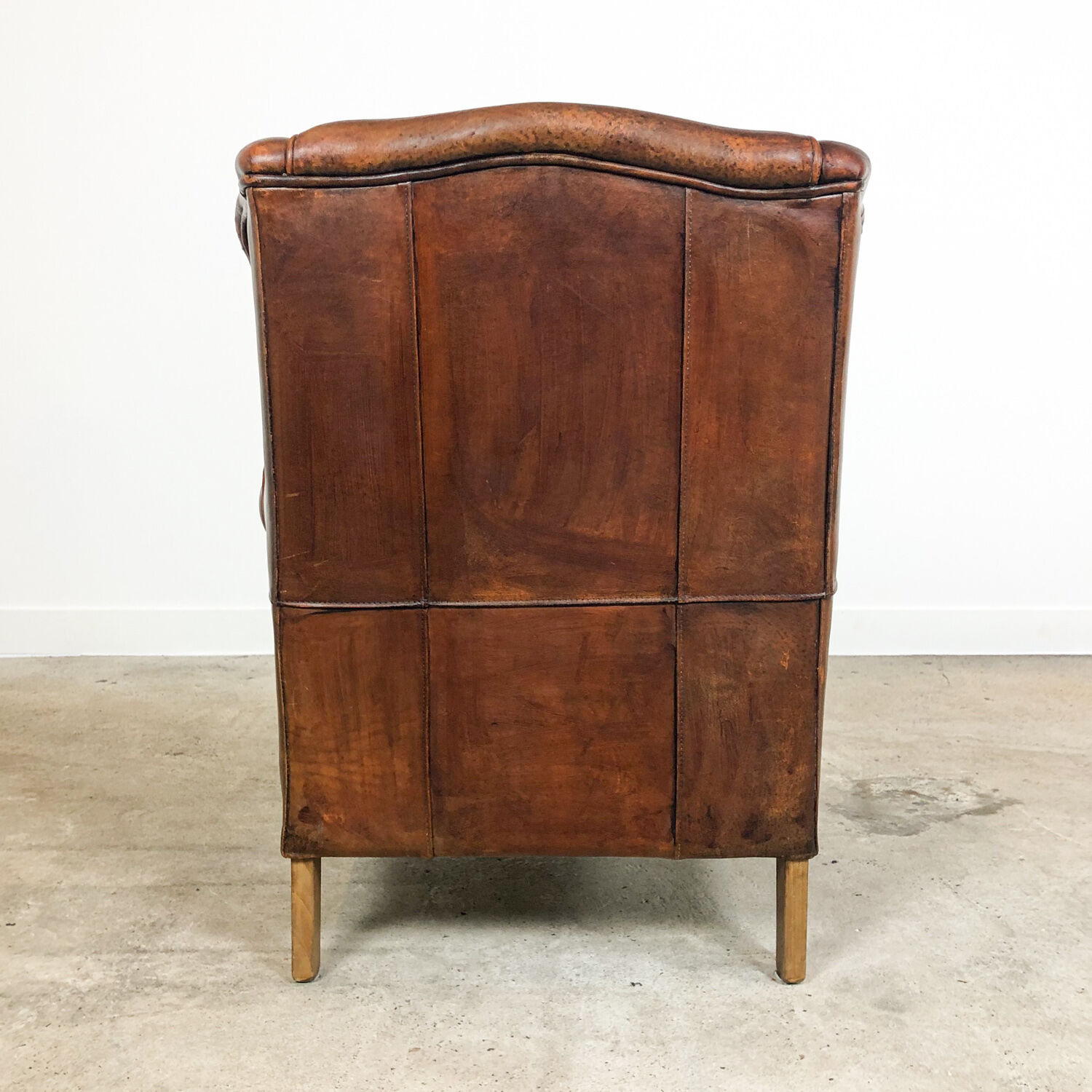 Dark brown sheep leather wingback armchair
