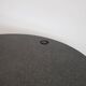 Round dining table in black lacquered metal with a granite top.