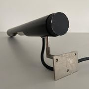 Minimalist black metal wall light with a cylindrical design, 1960s, Germany.