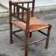 Brutalist corner chair in turned wood with straw bobbins, 1960.