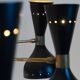 Diabolo chandelier in patinated and black lacquered brass. Contemporary.