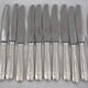 12 dessert, cheese, and hors d'oeuvre knives Grand Prix, Art Deco in silver-plated metal.