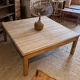 Large square antique coffee table made of raw solid wood.