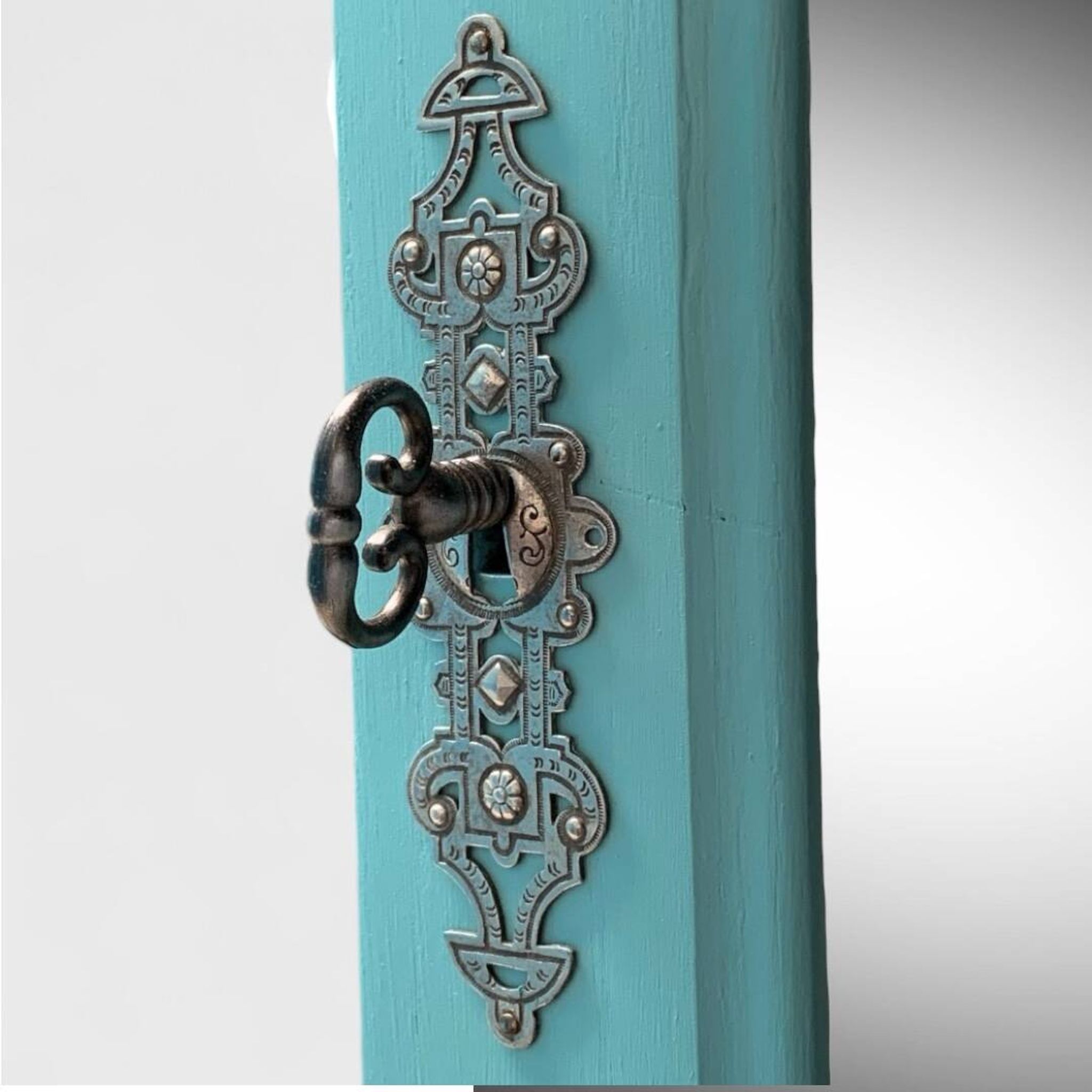 Beveled mirror on turquoise Parisian door