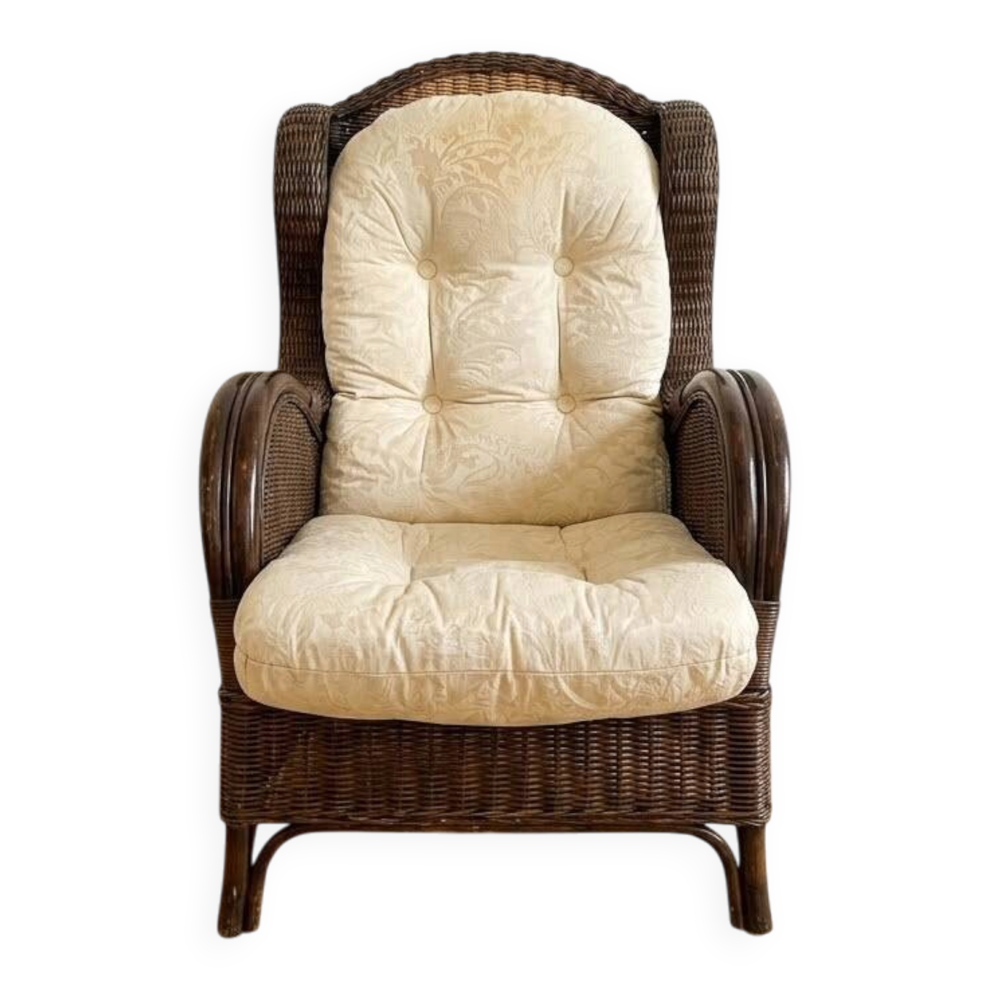 Vintage armchair in rattan and wicker with beige cushion.