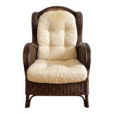 Vintage armchair in rattan and wicker with beige cushion.