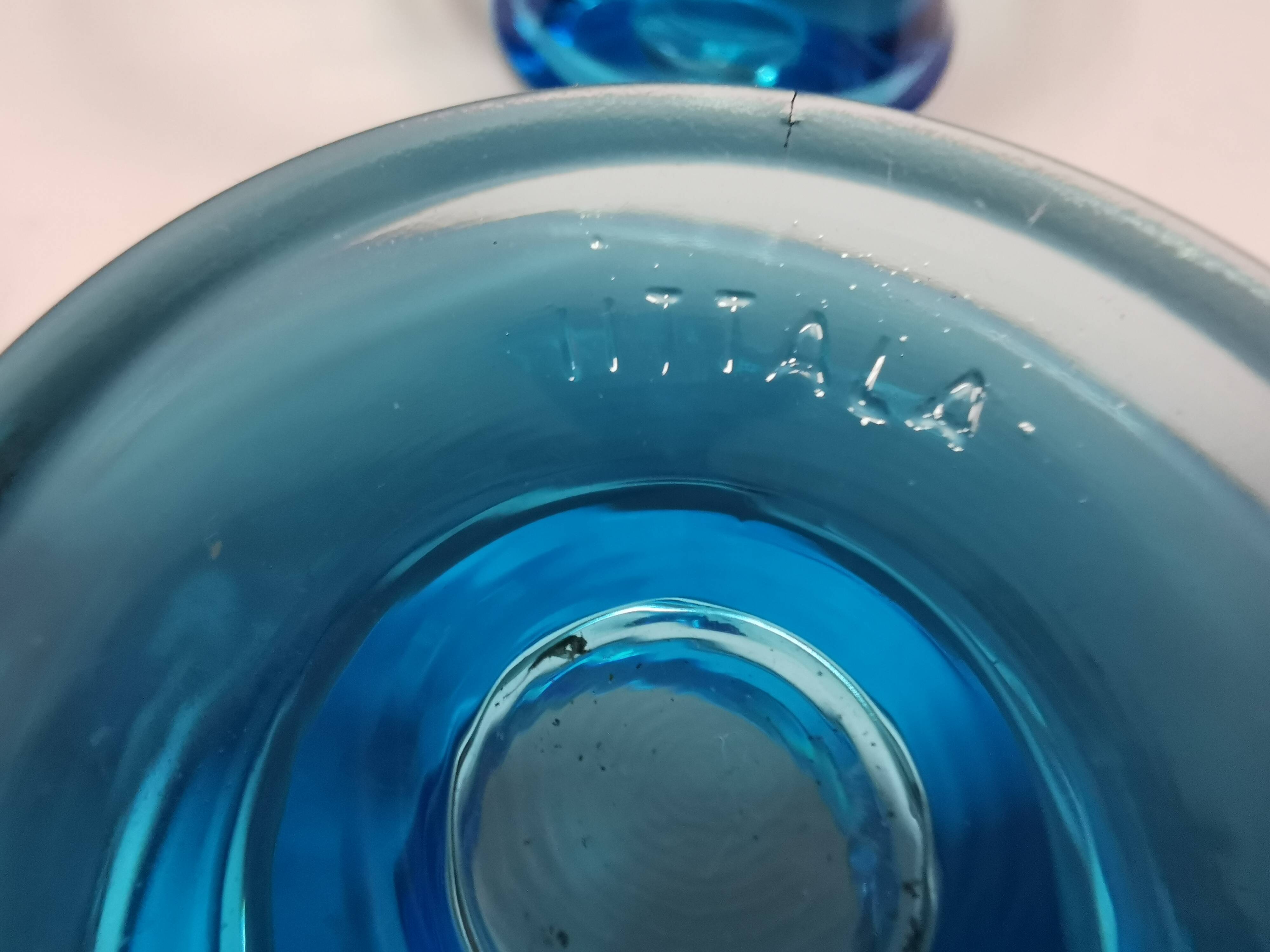 Two small candle holders in blue glass from the well-known Finnish company Ittala.