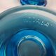 Two small candle holders in blue glass from the well-known Finnish company Ittala.