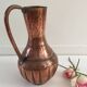 Pitcher-shaped vase in hammered copper