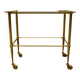 Antique brass serving trolley with smoked glass top, Louis XVI style.