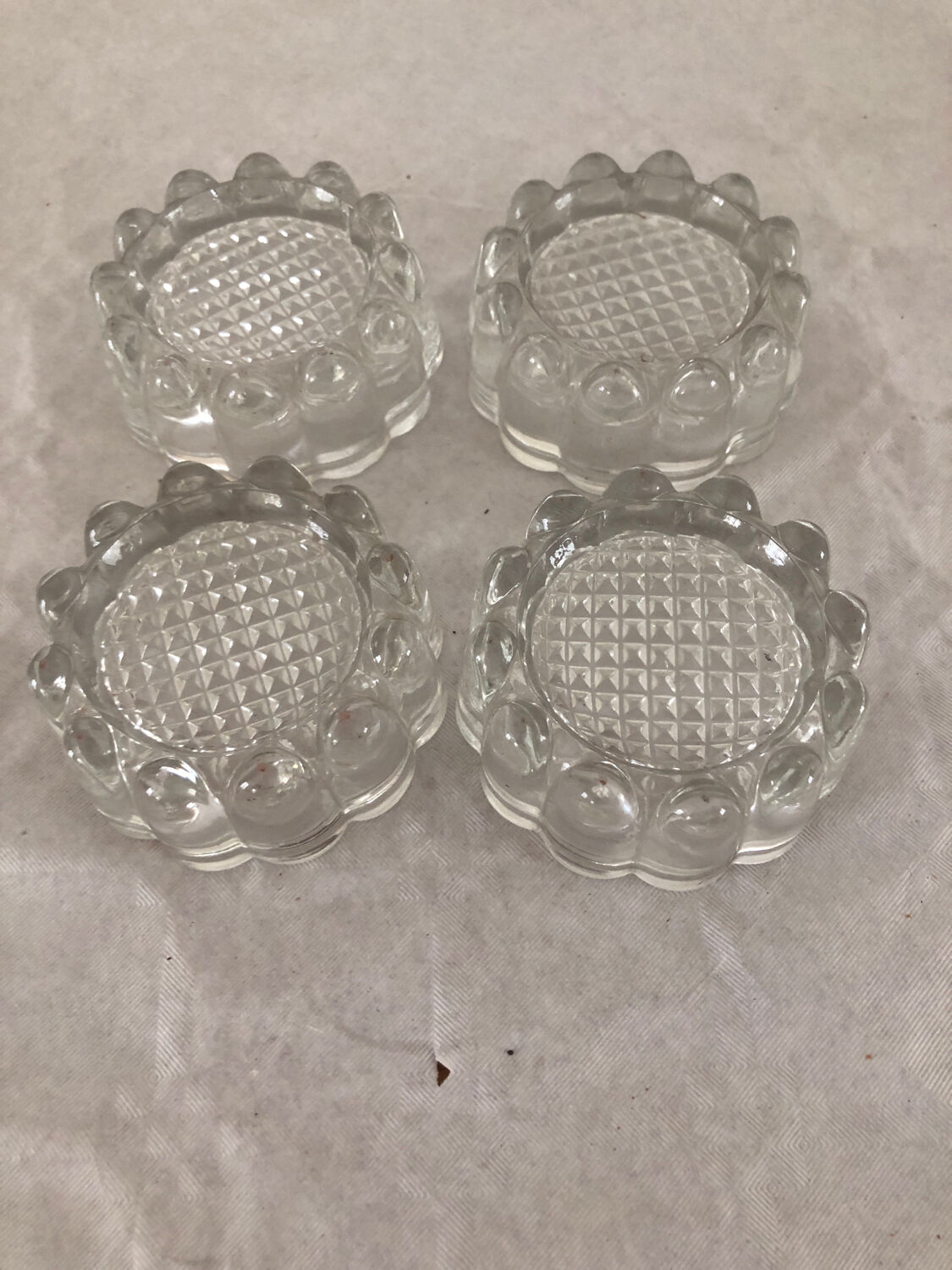 4 flat glass candle holders cut in the shape of Vintage flowers