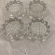 4 flat glass candle holders cut in the shape of Vintage flowers