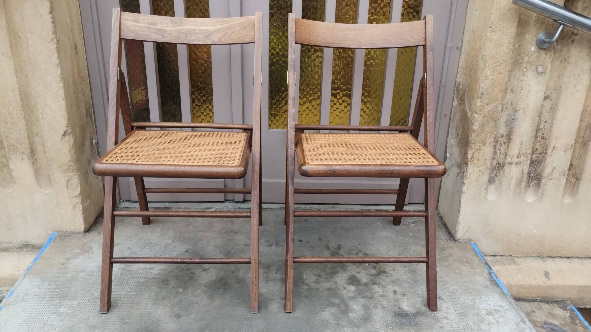 Pair of vintage wooden and cane folding chairs