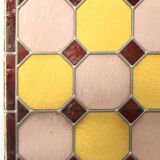 Old stained glass window with geometric patterns