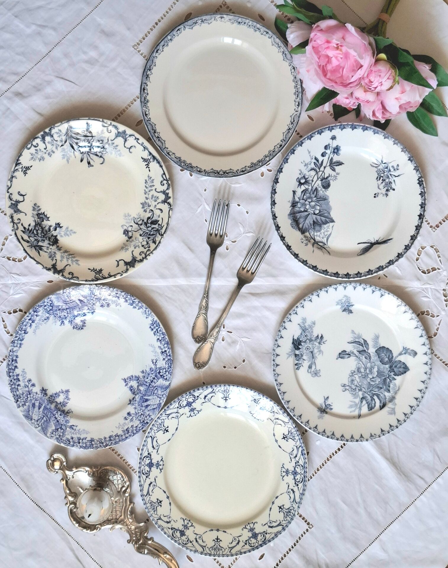 Old mismatched flat plates made of ironstone earthenware.