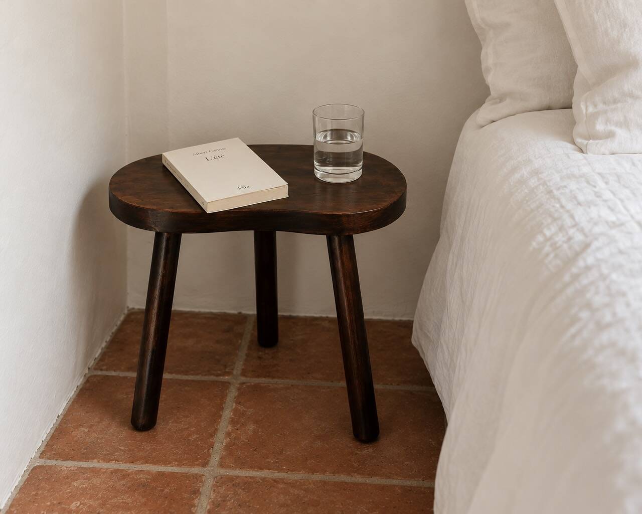 Wooden tripod bedside or occasional table, bean-shaped top.