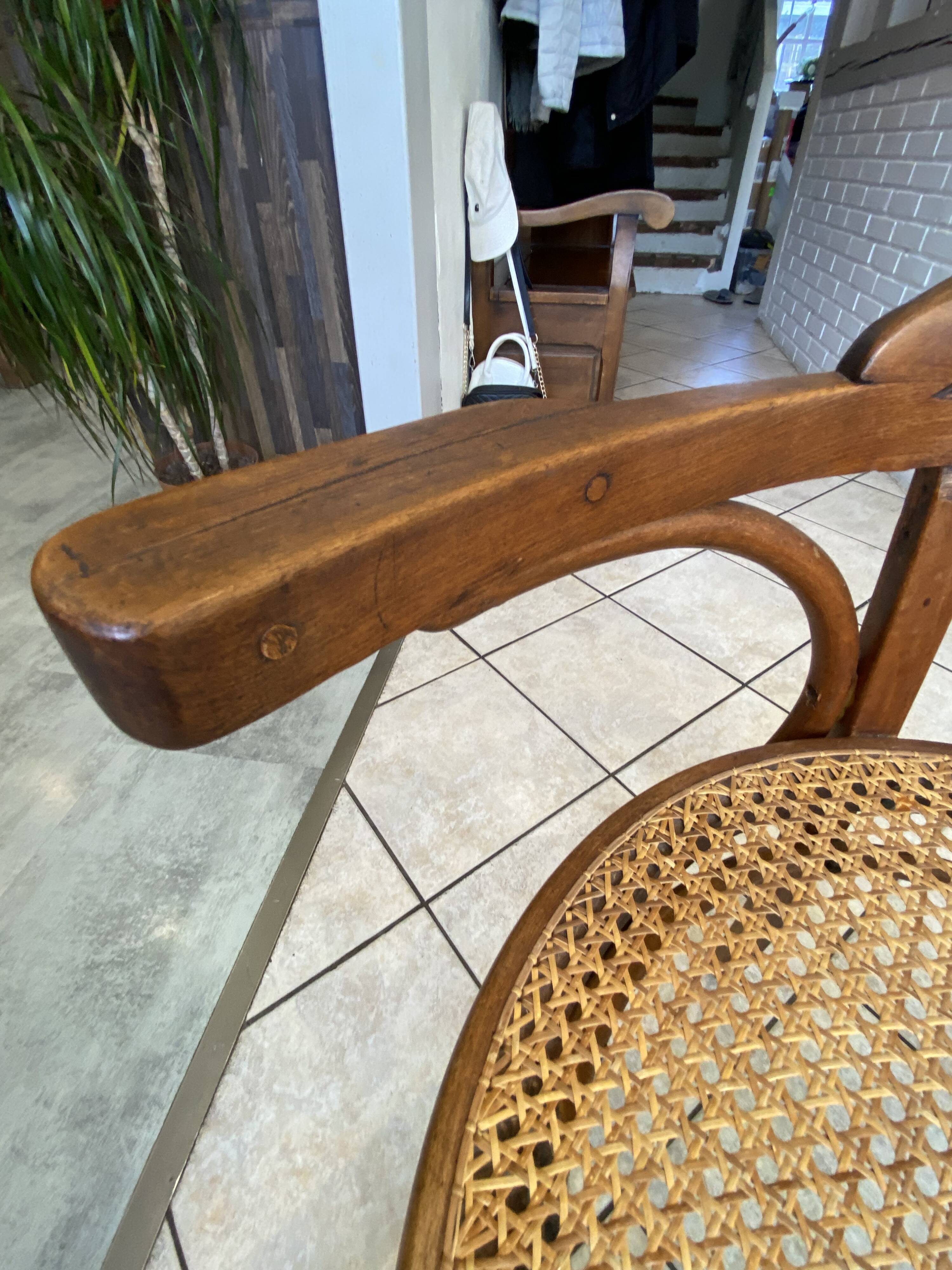 Bistro chair with a curved wooden frame and caned seat from the 1930s.