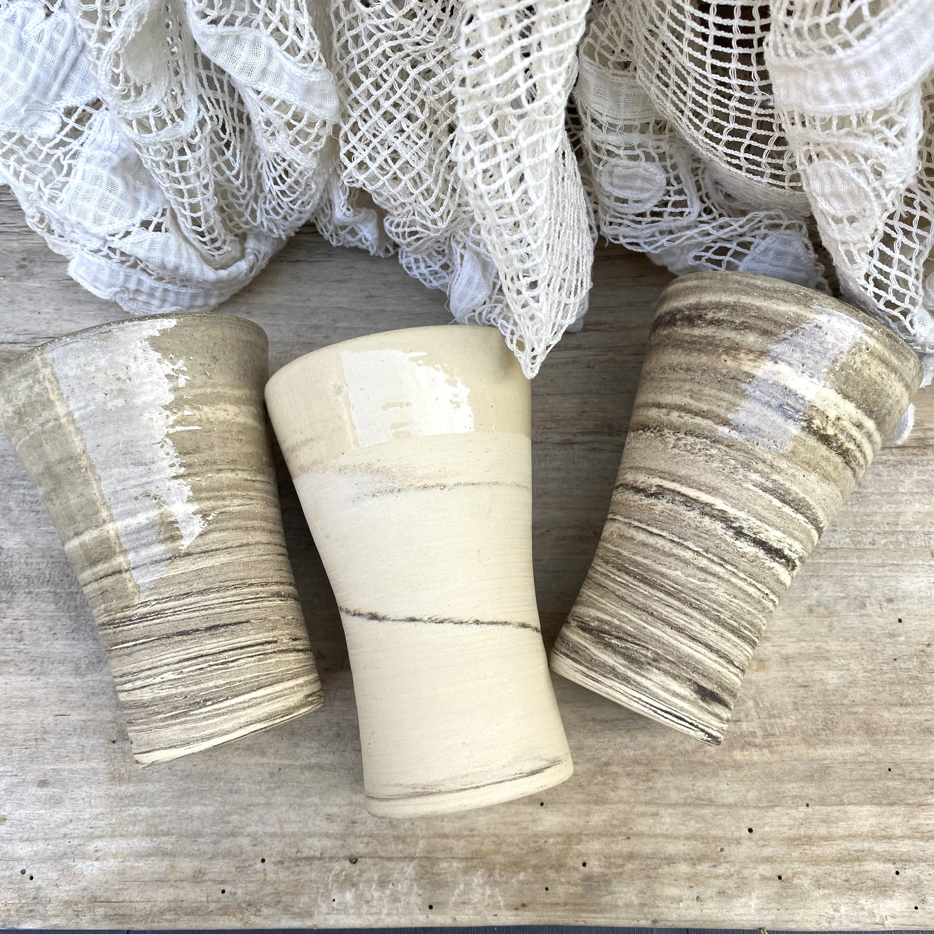 High ceramic cups made of mixed clay.