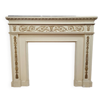 Louis XVI fireplace made in the 19th century, all in lacquered and gilded wood with decorative attributes