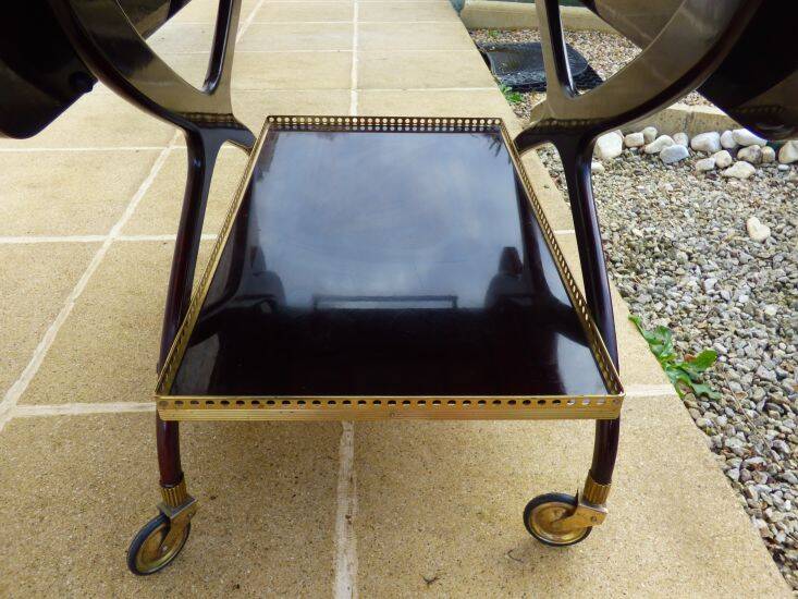 Chic serving table on wheels from the 60s with brass decorations and two shelves.