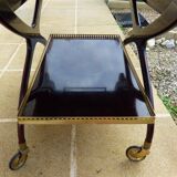Chic serving table on wheels from the 60s with brass decorations and two shelves.