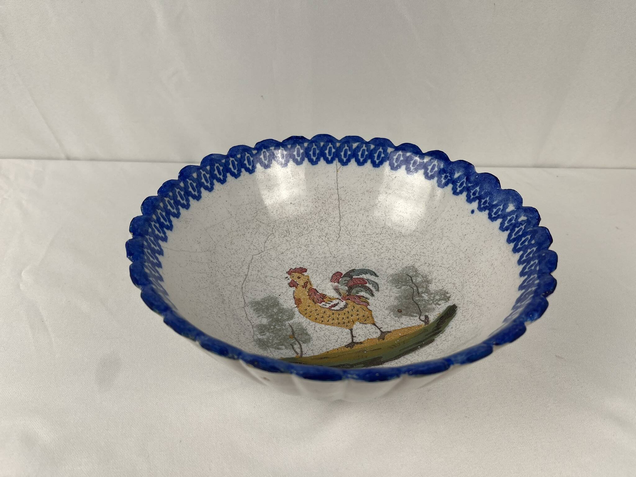Regional earthenware small hollow dish decorated with 20th century rooster